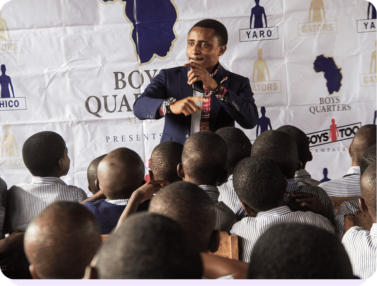 Man speaking to a group of boys at an event